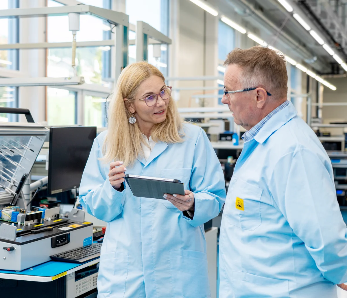 Andreea Matei and Dan Negrea from Cicor discussing medical device development in a production environment.