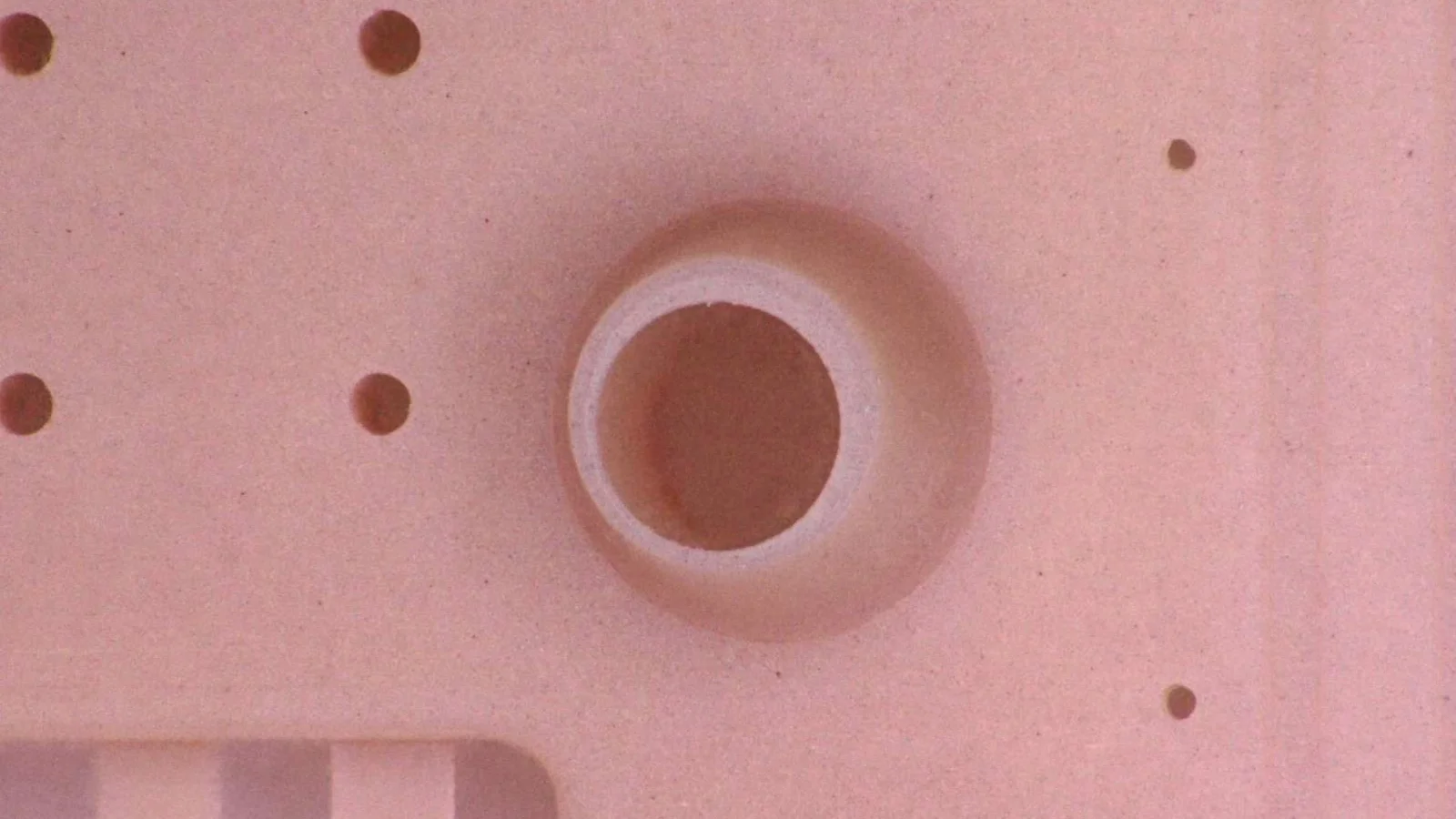Close-up of a micro-molded plastic part demonstrating Cicor's precision plastics capabilities.
